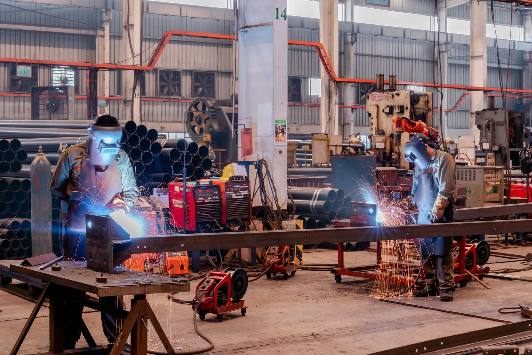 Industrial workers performing fabrication work